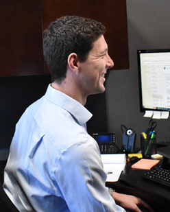 A McDowell Rice attorney at work in front of monitors at his desk.